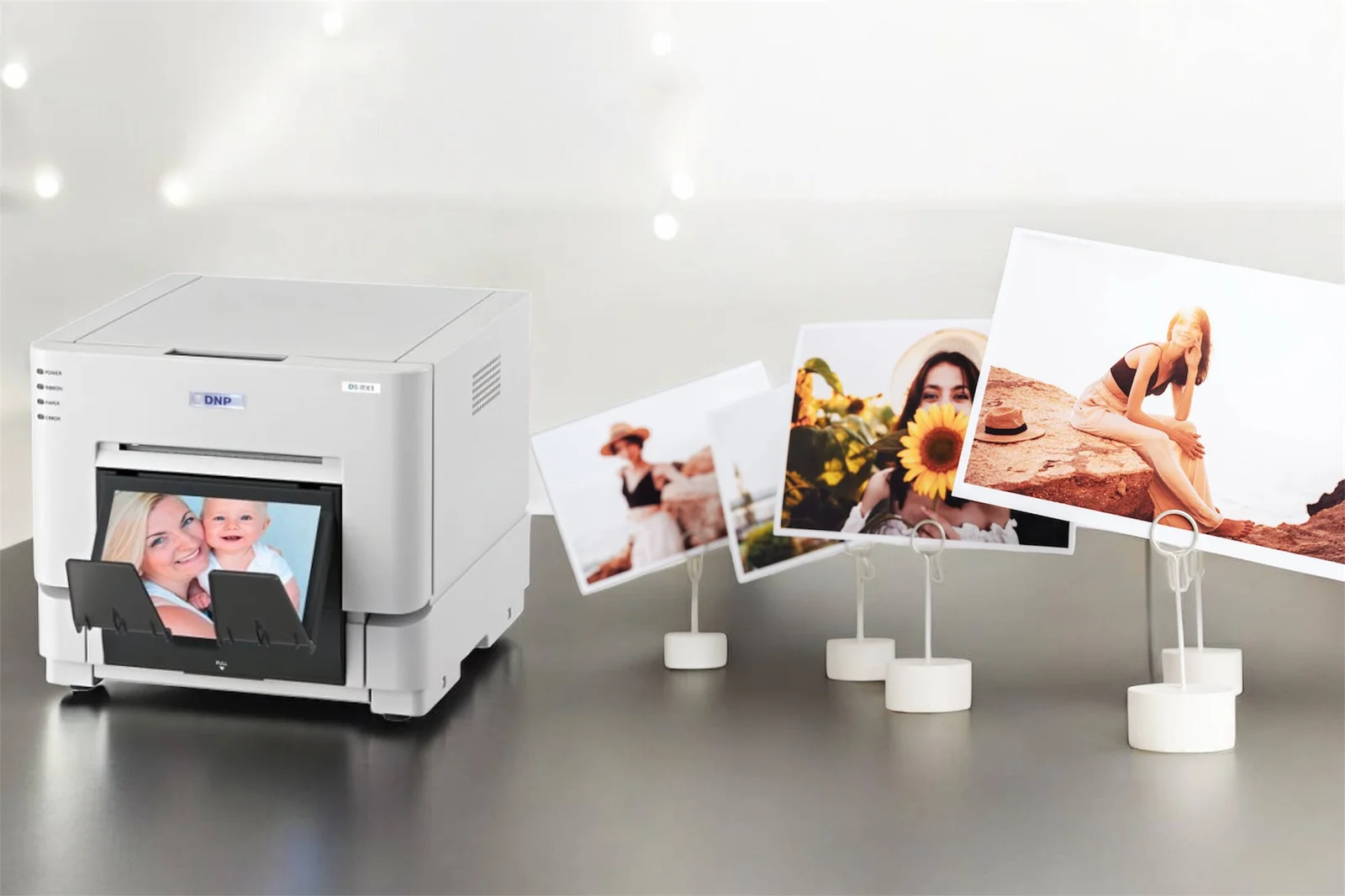Photo printer with finished 4x6 prints on display